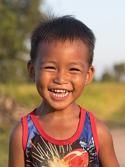 Laughing boy at golden hour, Laos