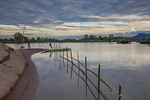 Children playing at sunset on a Mekong bank in Si Phan Don