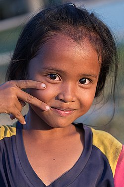 Portrait of a smiling girl at golden hour with catch light in Laos