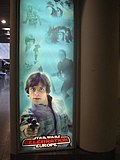 X is the poster (allowed as the copyright holder of the poster released this photograph under a free license).